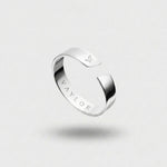 Silver ring on a light gray background